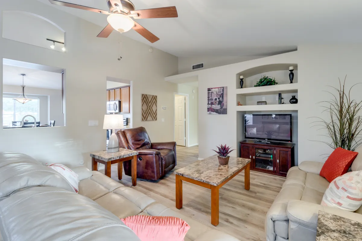 This image features a leather recliner prominently positioned in a stylish living area. The marble-top coffee table and sleek TV unit contribute to an atmosphere designed for comfort and entertainment. Warm lighting and modern decor create a welcoming, sophisticated setting perfect for gathering and unwinding.